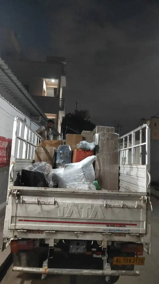 Packers and Movers team loading cushioned household goods into truck for Bangalore to Hyderabad relocation