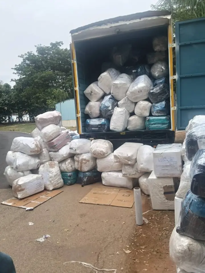 Real photo of luggage bags, boxes, and parcels loaded in container truck for Bangalore to Hyderabad transport